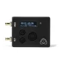 Atomos AtomX Ultrasync One belaidis laiko kodų siųstuvas su OLED ekranu, rodančiu laiko kodą, ir dviem LTC/RF jungtimis