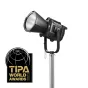 Godox MG1200Bi Bi-color Knowled Light Kit 2, sumontuotas ant sidabrinio stovo, su dideliu baltu difuzoriumi, juodu korpusu su modelio numeriu 'MG1200Bi' šone ir U formos laikikliu montavimui. Šone matoma maža antena ant balto fo