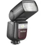 Godox Speedlite V860III blykstė, sumontuota ant kameros su belaidžiu trigeriu, su stačiakampiu difuzoriumi ir LED indikatoriumi, matomas 'Godox' logotipas bordo fone.