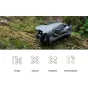 DJI Mini 5 Pro dronas su kamera ir propeleriais ant samanoto rąsto miške
