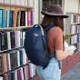 Peak Design Everyday Backpack Zip V2 15L tamsiai mėlyna spalva, pagaminta iš orui atsparaus 400D perdirbto nailono, nešiojamas žmogaus miesto knygų parduotuvėje