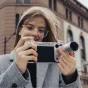 Vintažiniu stiliu įkvėptas iPhone 17 Pro Max kameros laikiklis su 2.35x telefoto objektyvu, taktiniais valdikliais ir odiniu apdailu profesionaliai fotografijai