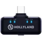 Hollyland Lark M3 4TX beveiksimų mikrofonų transmičius su USB‑C įjungjuju, ketri žalios TX1‑TX4 žymės, juosčiai kūras ir Hollyland logotipas.